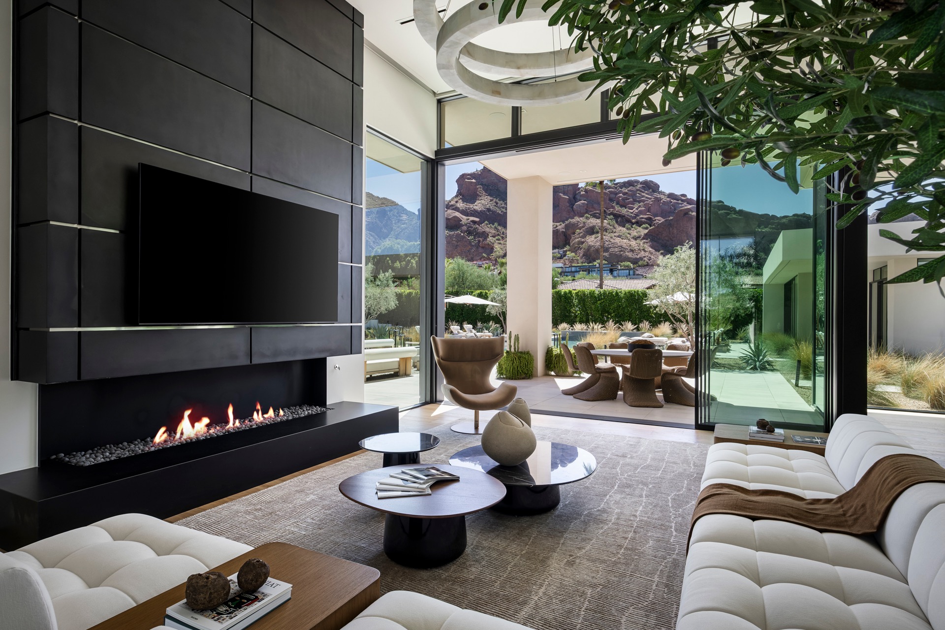 Modern living room with a fireplace and desert mountain views